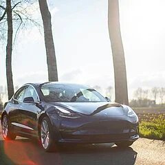 Tesla Autopilot driving visualization on the center display showing surrounding traffic