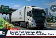 Modern electric semi-truck charging at a high-power depot with wind turbines in the background showcasing green fleet technology in 2026