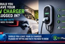 Modern electric vehicle plugged into a home wallbox charger in a clean residential garage, showing the connected cable and status light